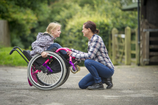 Good body mechanics and proper lifting techniques are so important for keeping your back and body healthy. As our kids with special needs and mobility restrictions get older, it is important to re-evaluate how they are lifted and carried to ensure everyone stays safe and healthy. Here are some suggestions for ways to set up and execute transfers to avoid injury.